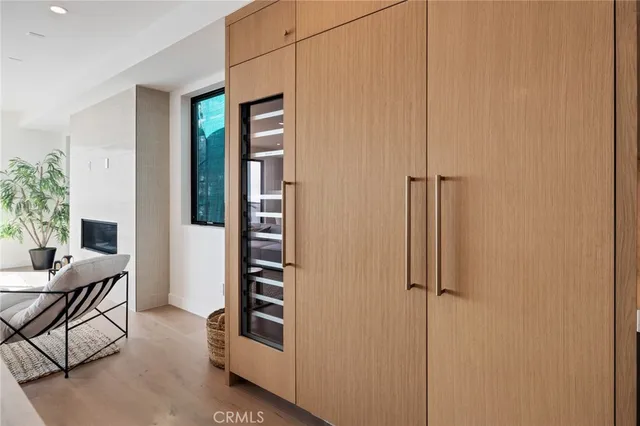 a bedroom with a large bed and a wooden floor