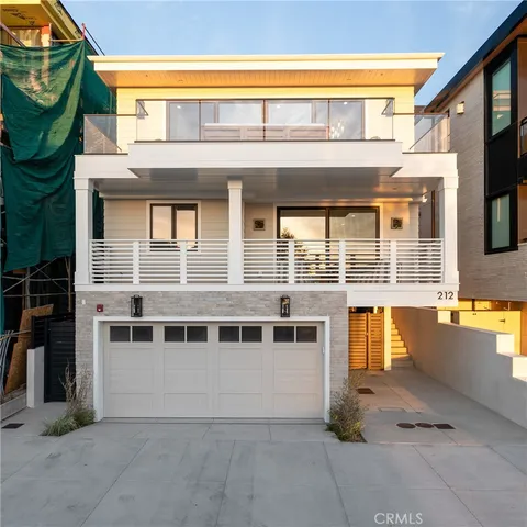 a view of a house with a balcony and a patio