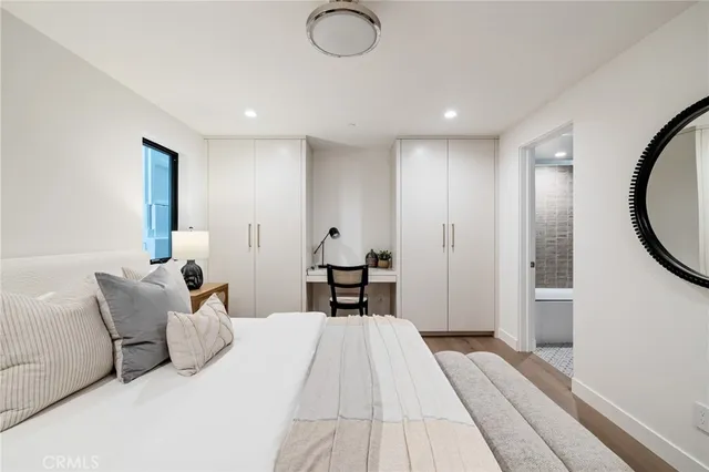 a bedroom with a bed and a potted plant