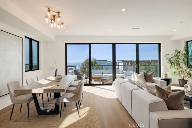 a living room with furniture and large windows