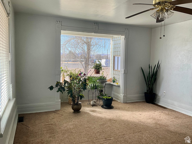 495 North Main Street Beaver, UT 84713 - Photo 18 of 18 Living area featuring ceiling fan, healthy amount of natural light, and carpet