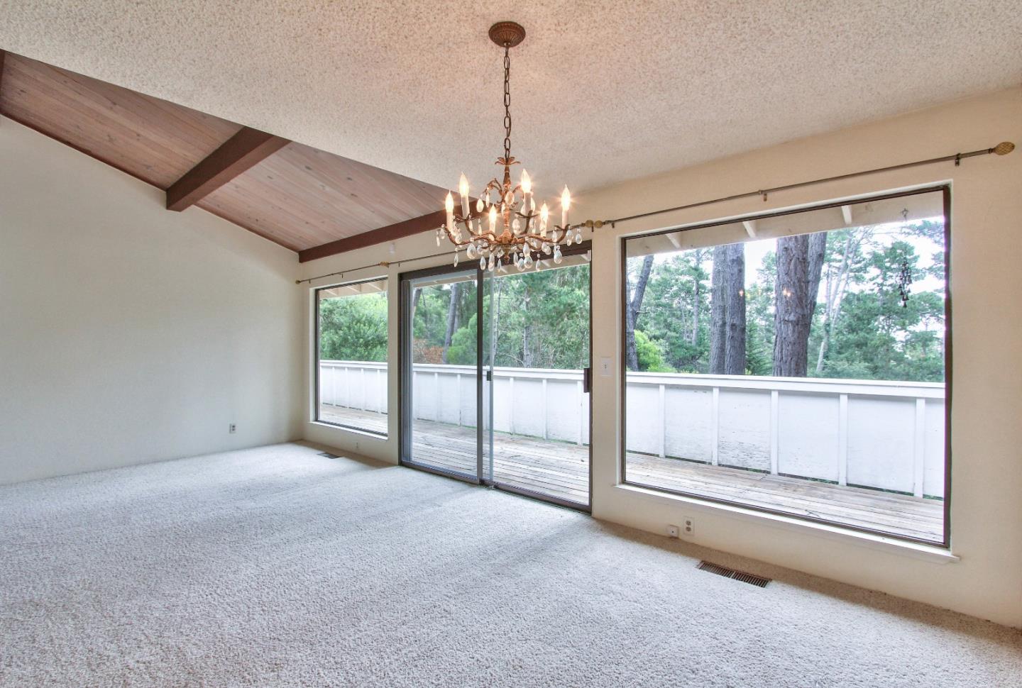 4025 Costado Road Pebble Beach, CA 93953 - Photo 5 of 21 a view of an empty room with windows and ceiling fan