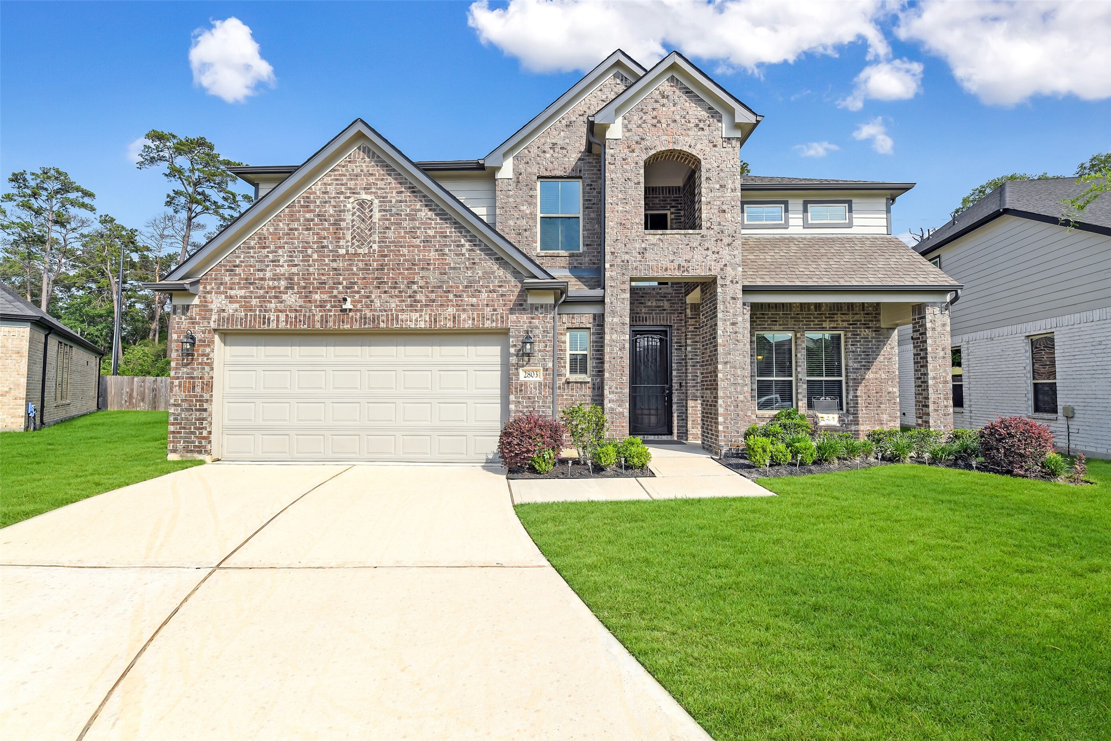 2803 Skerne Forest Dr Spring Spring, TX 77373 - Photo 1 of 44 a front view of a house with a yard and garage