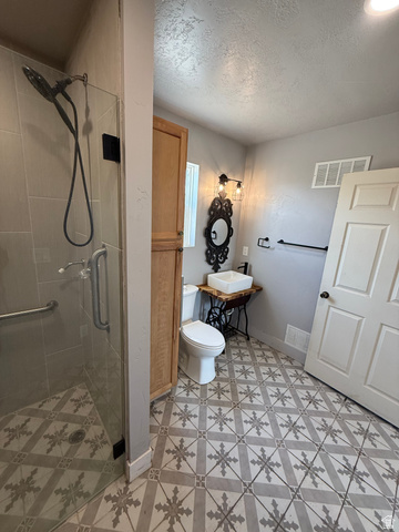 14183 High Mesa Loop Duchesne, UT 84021 - Photo 20 of 56 Full bathroom with a shower stall and a textured ceiling