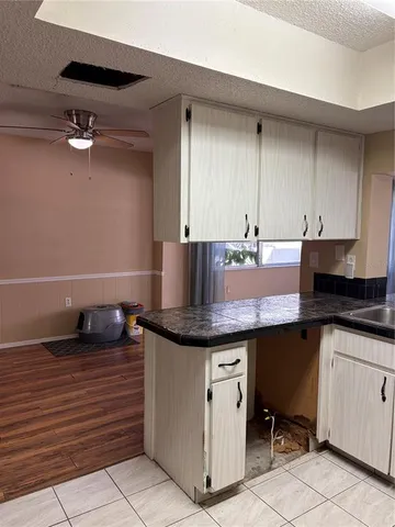 a kitchen with granite countertop a sink and a stove