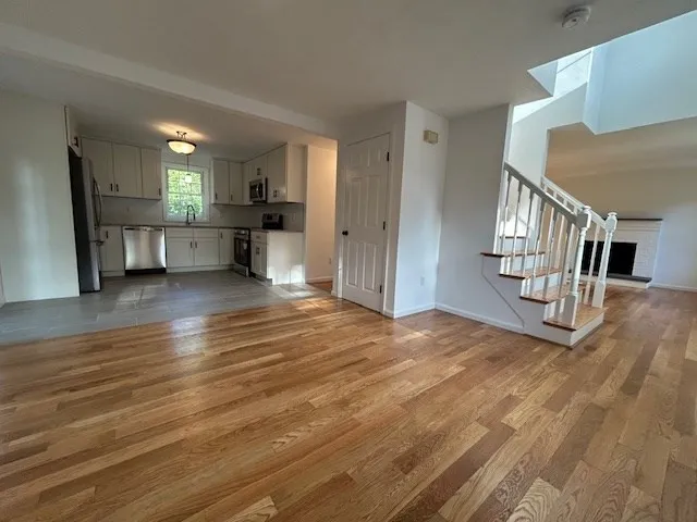 a view of a kitchen with a sink and a refrigerator