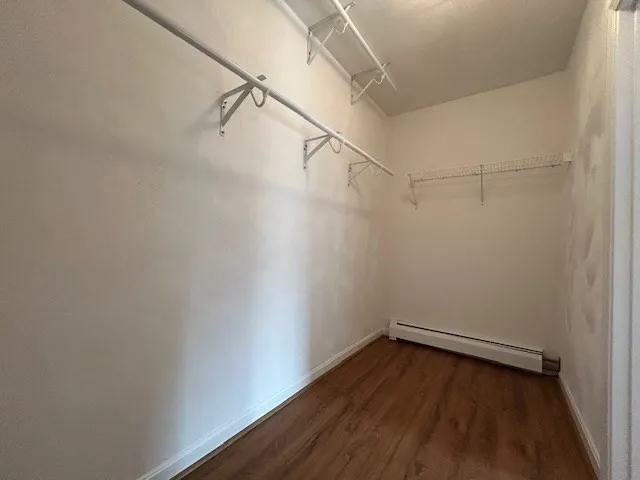a view of a room with wooden floor and entryway