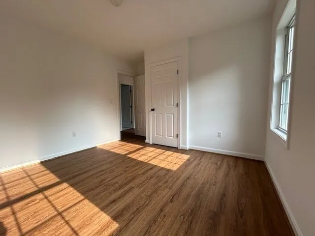 a view of an empty room and wooden floor