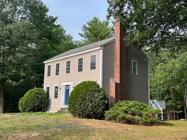 a view of a house with a yard and plants