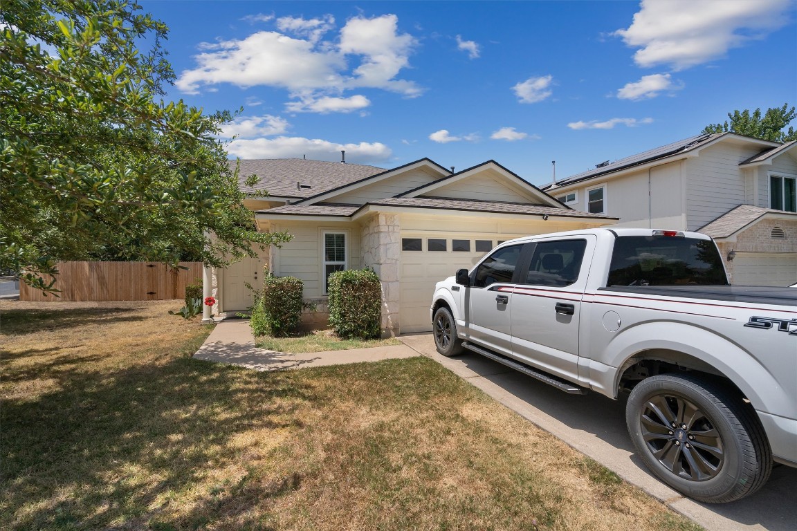 a view of a car park in front of house