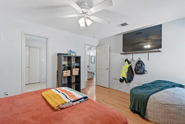 a bedroom with a bed and a flat screen tv
