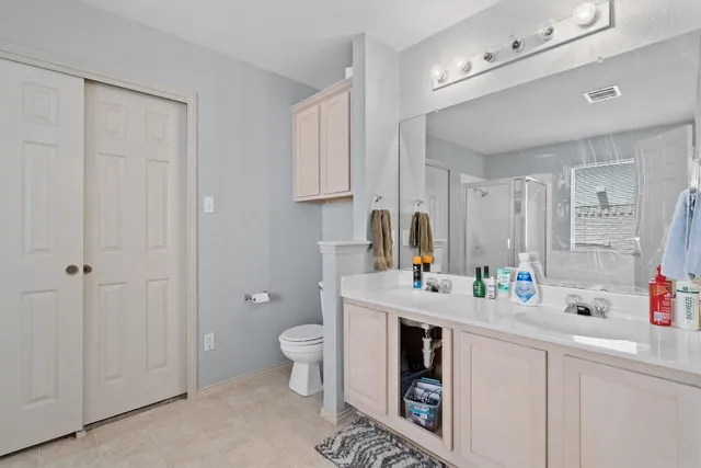 a bathroom with a toilet sink and mirror