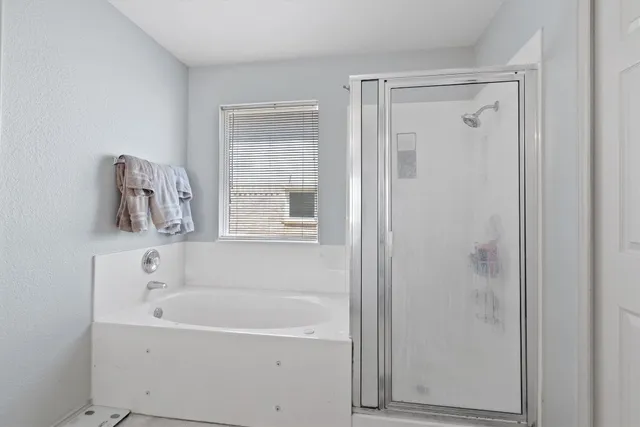 a white bath tub sitting next to a window