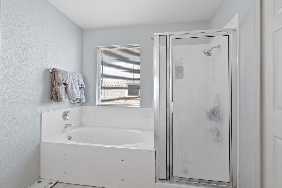 2601 Turtle River Drive Leander, TX 78641 - Photo 14 of 32 a white bath tub sitting next to a window