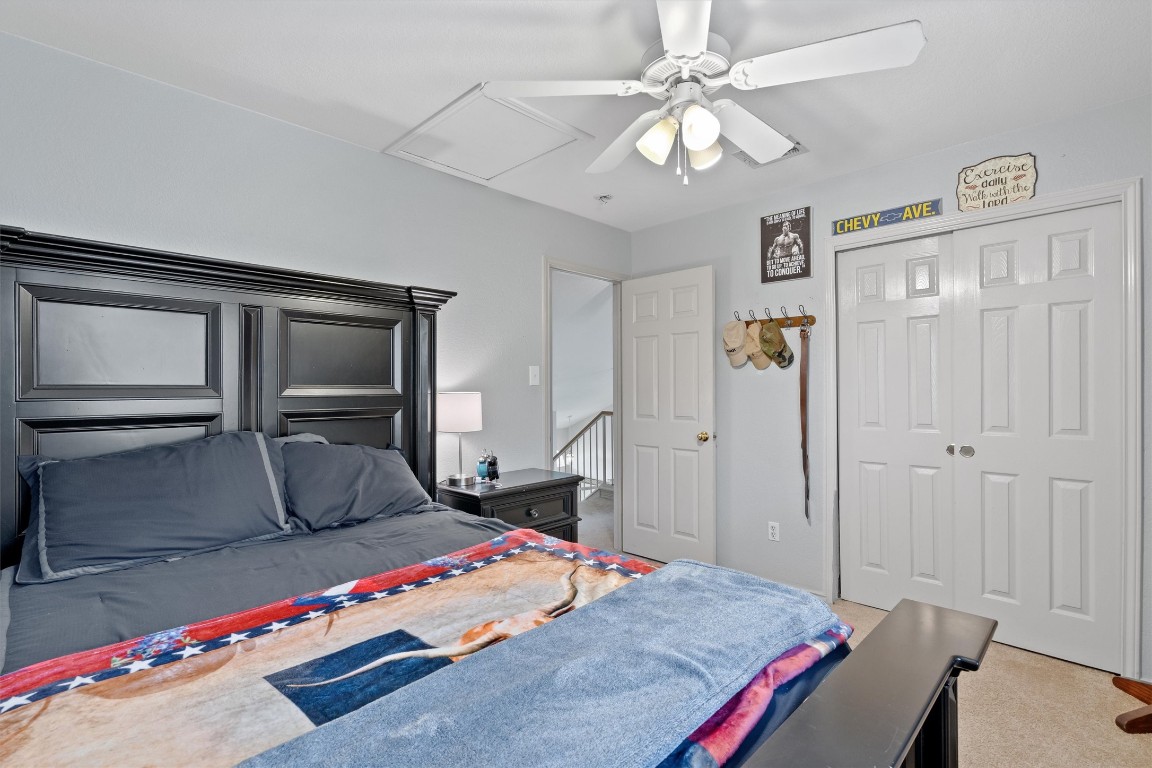 2601 Turtle River Drive Leander, TX 78641 - Photo 20 of 32 a bedroom with a bed and a chandelier