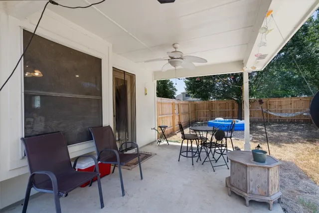 a backyard of a house with table and chairs