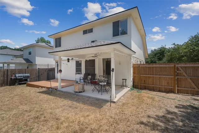 a backyard of a house with table and chairs