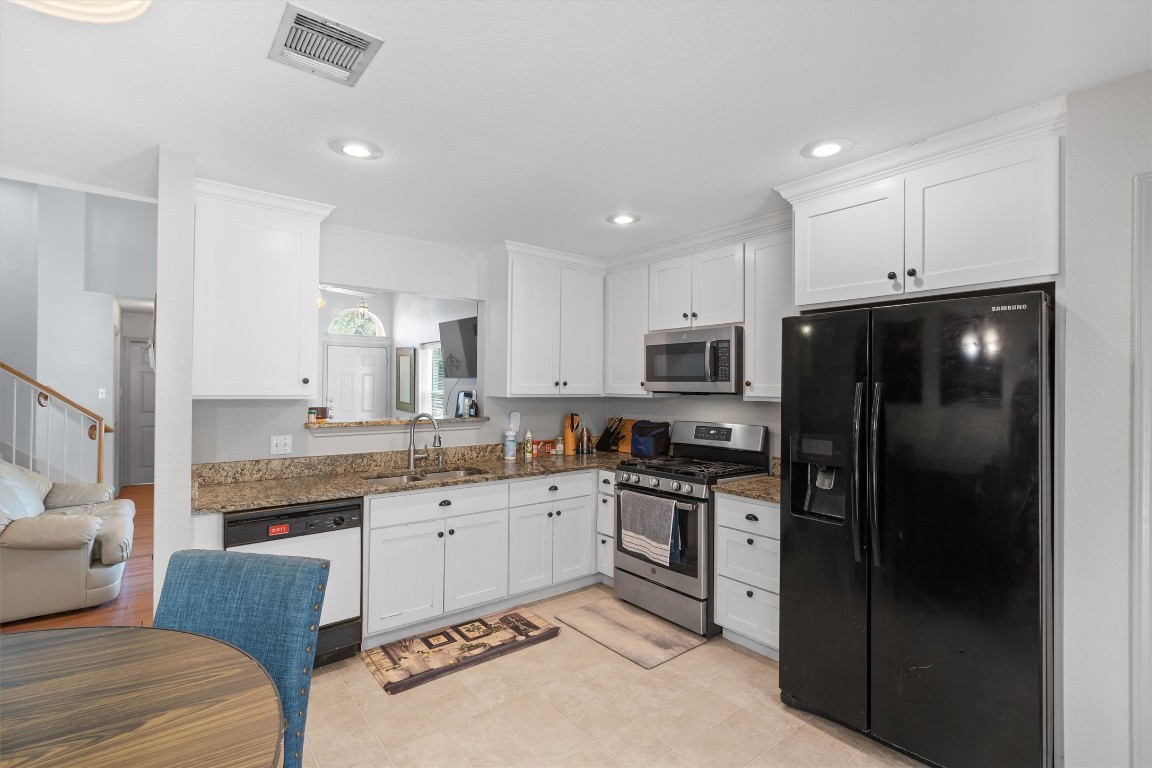 2601 Turtle River Drive Leander, TX 78641 - Photo 7 of 32 a kitchen with a sink stainless steel appliances and cabinets