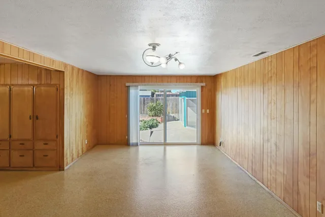 an empty room with windows and closet
