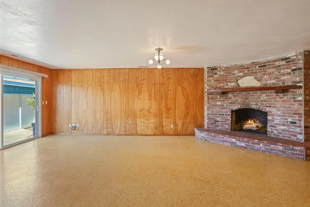 a view of an empty room with a fireplace