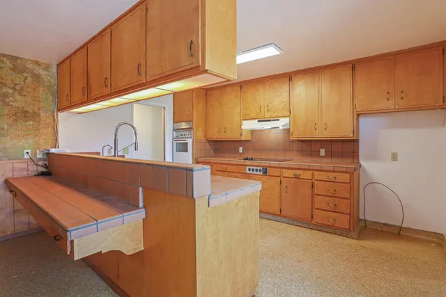 a kitchen with cabinets appliances and a sink