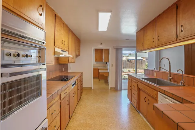 a kitchen with counter top space stainless steel appliances and cabinets