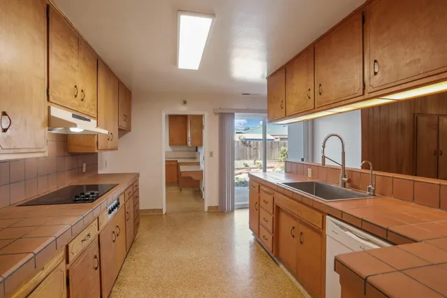 a kitchen with sink a stove and refrigerator