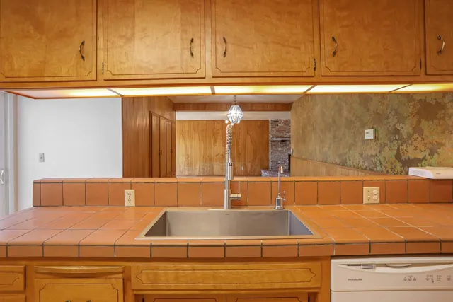 a kitchen with a sink and cabinets