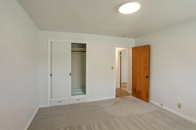 an empty room with closet area