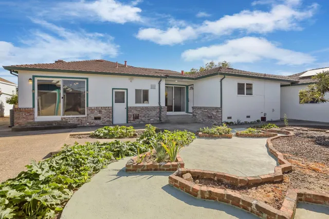 a view of a house with swimming pool and sitting area
