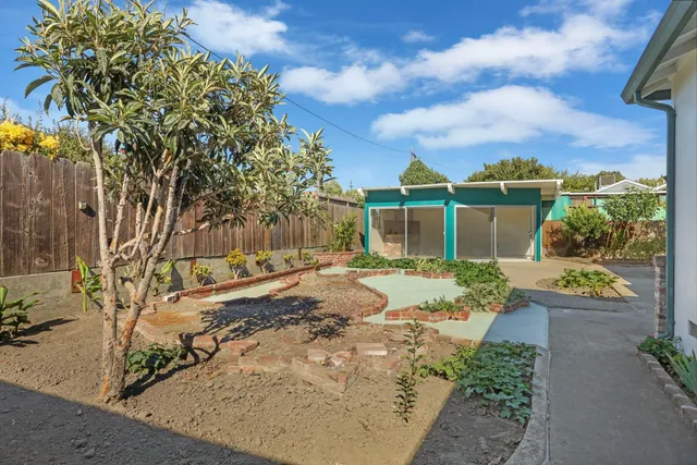 a large white kitchen with a sink and glass doors