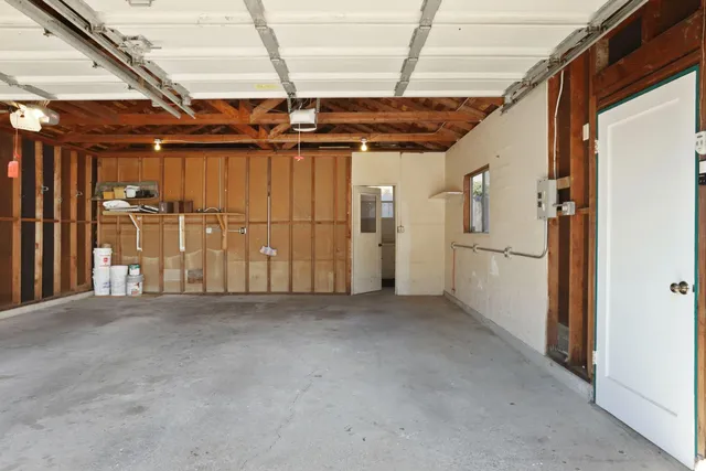 a bathroom with a double vanity sink a mirror and a bathtub