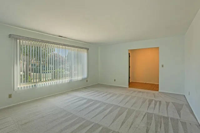 a view of an empty room with glass door