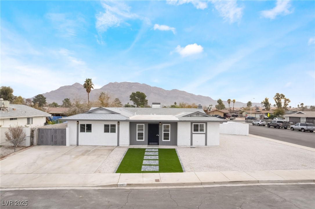 652 Red Lake Way Las Vegas, NV 89110 - Photo 2 of 66 Ranch-style home featuring a mountain view, stucco siding, and a chimney