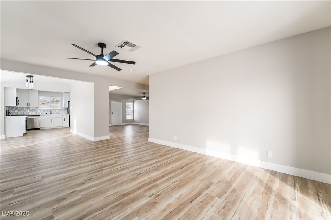652 Red Lake Way Las Vegas, NV 89110 - Photo 23 of 66 Unfurnished living room featuring light wood-style flooring and a ceiling fan