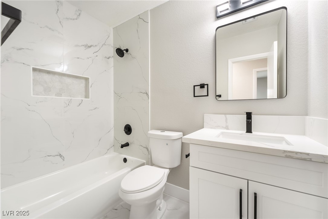 652 Red Lake Way Las Vegas, NV 89110 - Photo 27 of 66 Bathroom featuring shower / bath combination, vanity, and marble look tile flooring