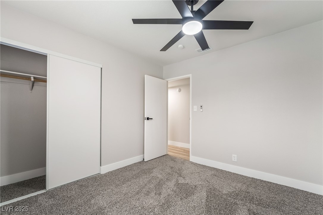 652 Red Lake Way Las Vegas, NV 89110 - Photo 30 of 66 Unfurnished bedroom featuring a closet, a ceiling fan, and carpet flooring