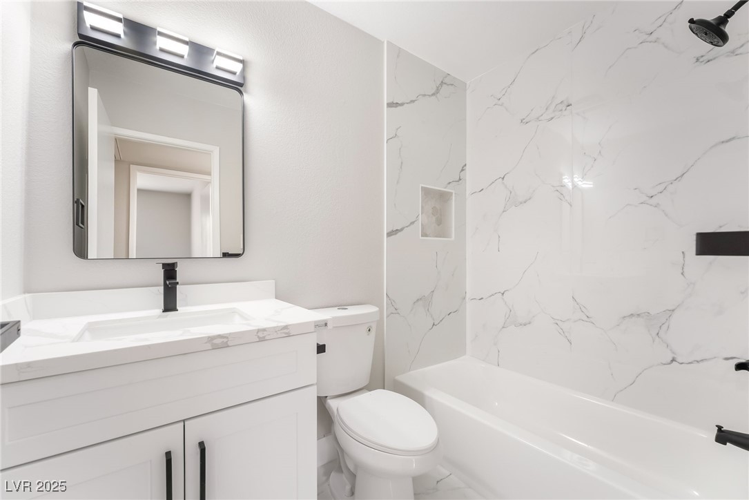 652 Red Lake Way Las Vegas, NV 89110 - Photo 32 of 66 Bathroom with vanity, shower / washtub combination, and marble finish flooring