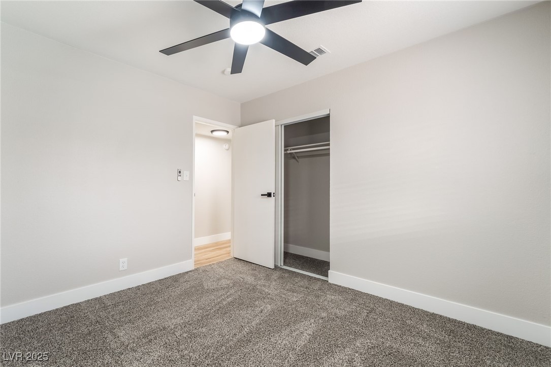 652 Red Lake Way Las Vegas, NV 89110 - Photo 34 of 66 Unfurnished bedroom with carpet flooring, a closet, and a ceiling fan
