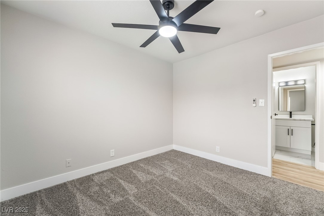 652 Red Lake Way Las Vegas, NV 89110 - Photo 35 of 66 Unfurnished bedroom with light colored carpet, ceiling fan, and ensuite bath