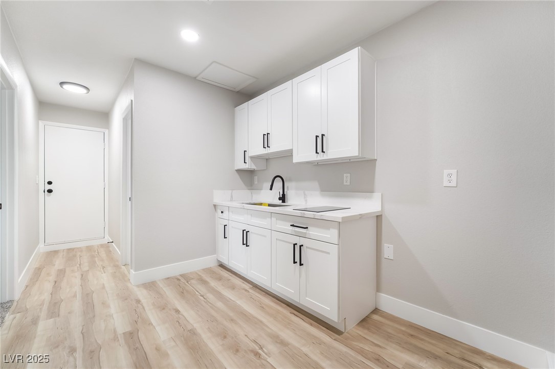 652 Red Lake Way Las Vegas, NV 89110 - Photo 37 of 66 Kitchenette cabinetry and light wood-style floors
