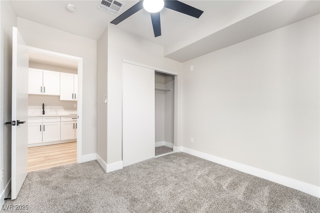 652 Red Lake Way Las Vegas, NV 89110 - Photo 38 of 66 Kitchenette featuring white cabinetry, light wood-type flooring, a ceiling fan, light stone counters, and recessed lighting