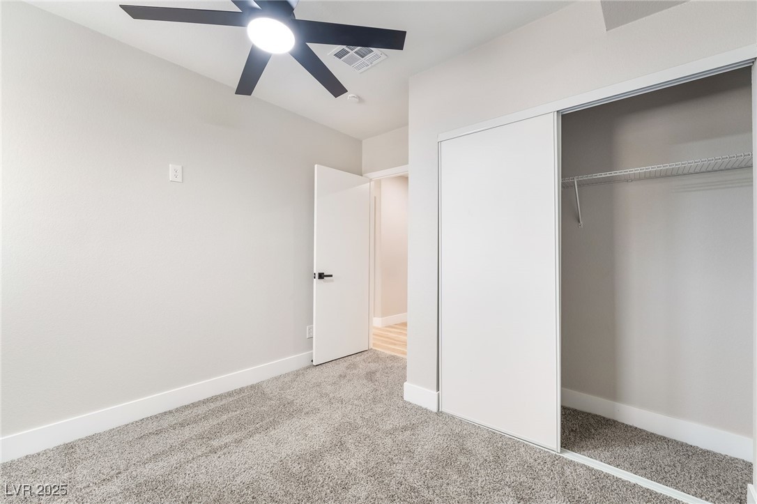 652 Red Lake Way Las Vegas, NV 89110 - Photo 40 of 66 Unfurnished bedroom with light carpet, a closet, and a ceiling fan