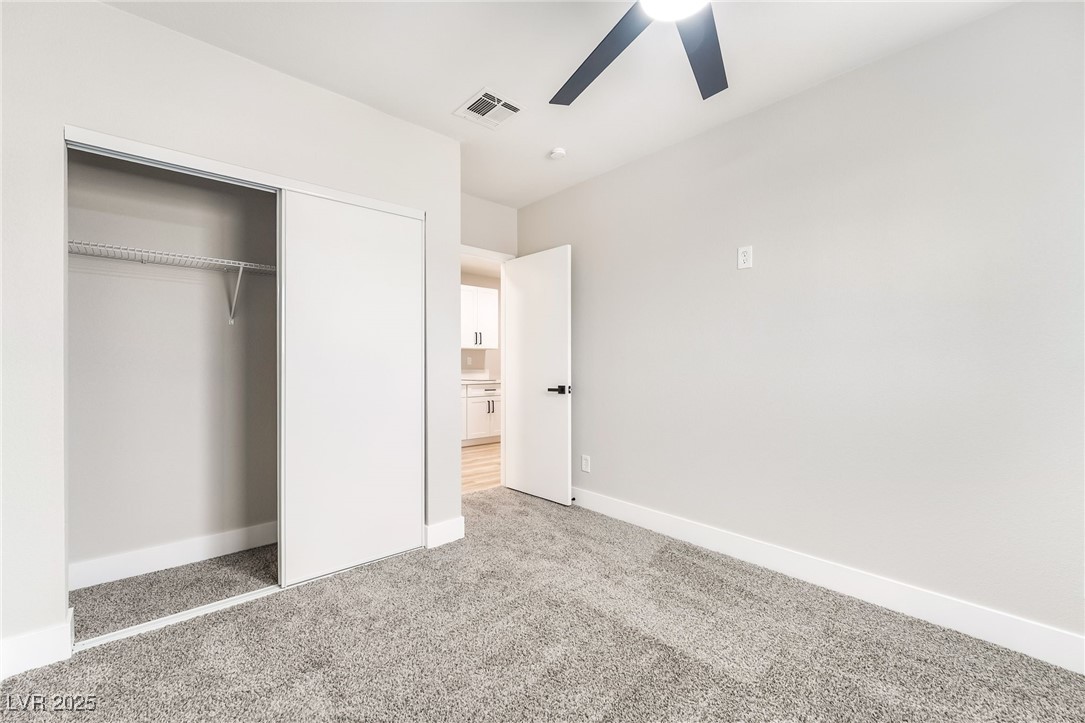 652 Red Lake Way Las Vegas, NV 89110 - Photo 42 of 66 Unfurnished bedroom featuring light colored carpet, a closet, and ceiling fan