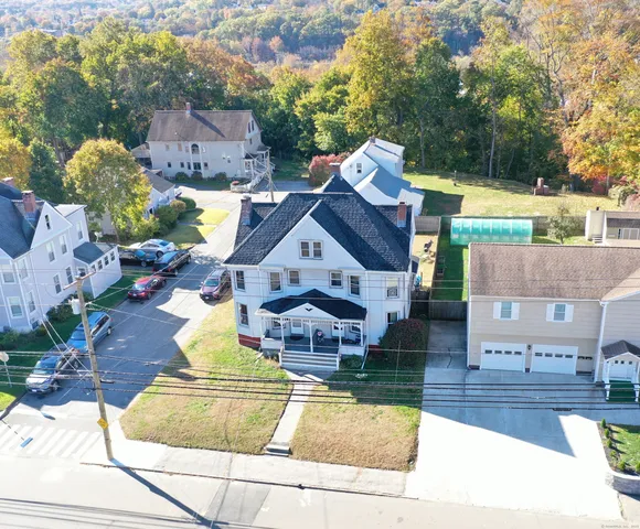 an aerial view of multiple houses with yard