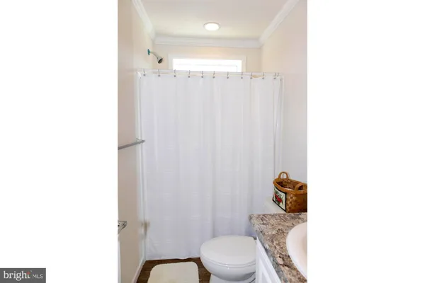 a bathroom with a toilet a sink and a shower