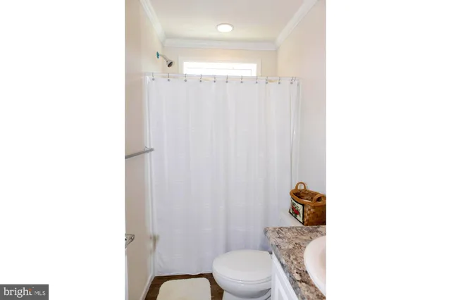 a bathroom with a toilet a sink and a shower