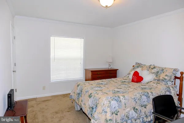 a bedroom with a bed and dresser