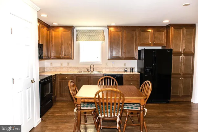 a kitchen with a table chairs sink refrigerator and microwave