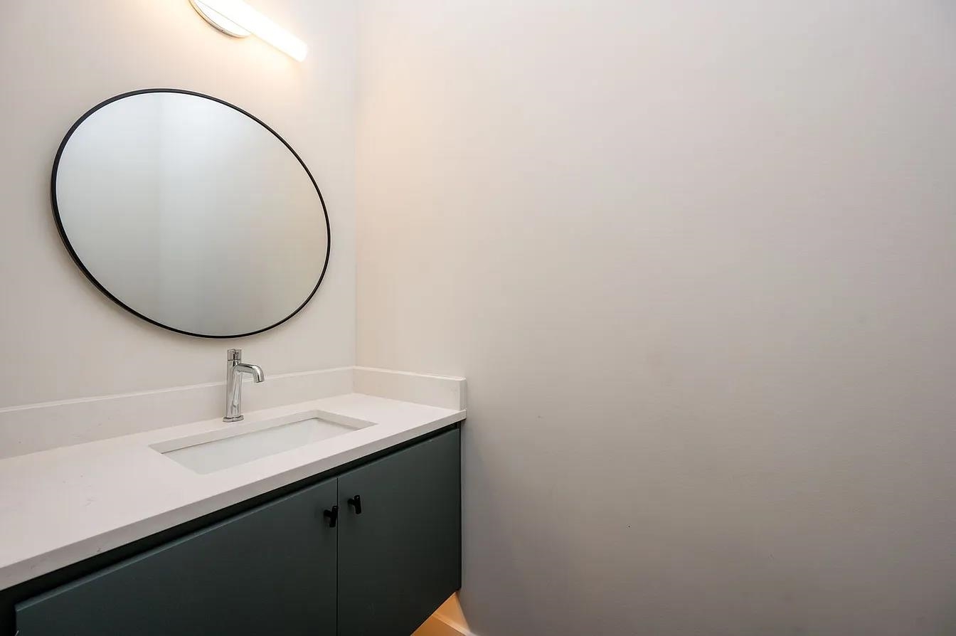 752 Meda Street Memphis, TN 38104 - Photo 15 of 18 Modern bathroom vanity with a white countertop and integrated rectangular sink